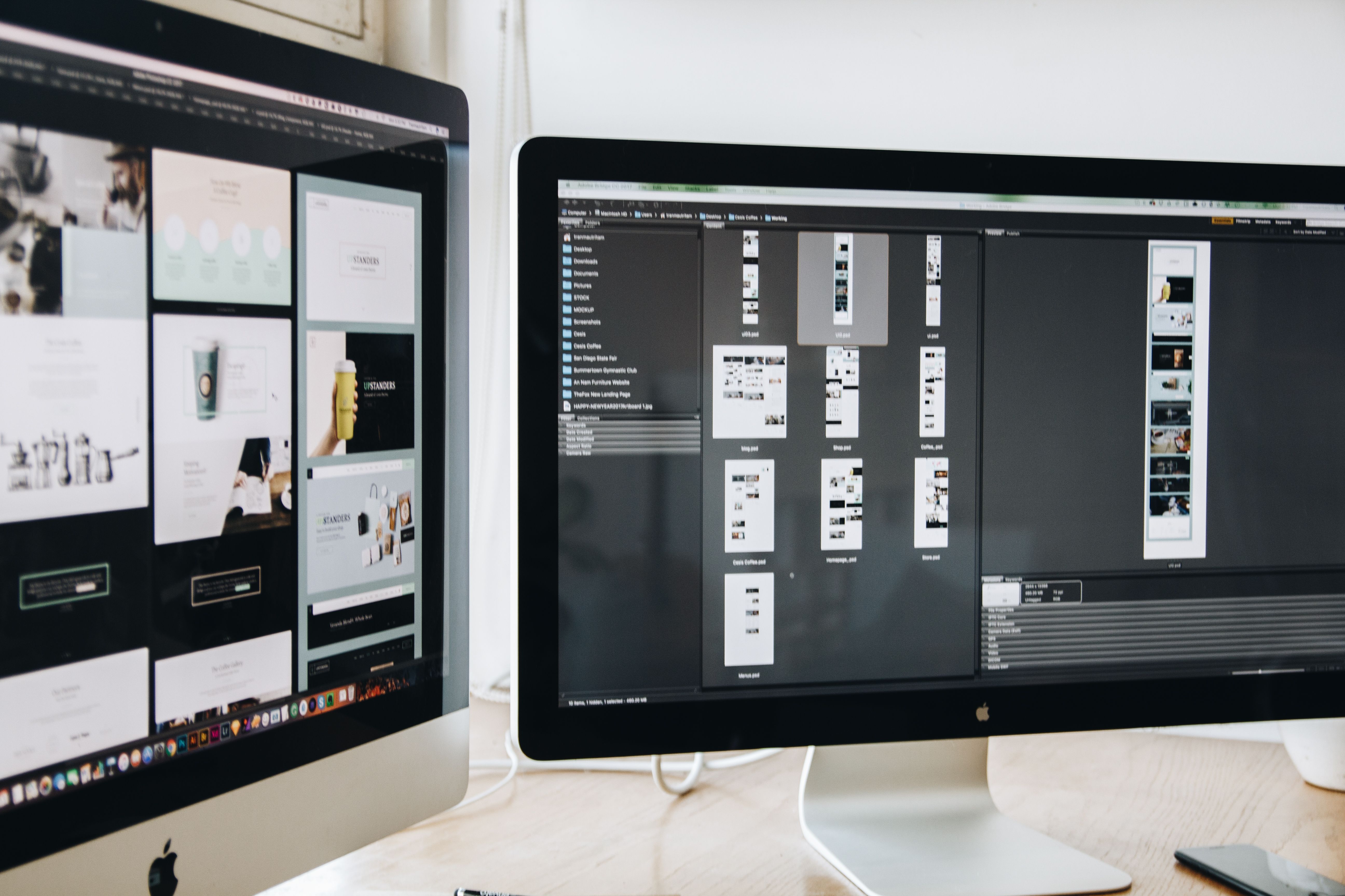 Web developer coding with dual monitor setup